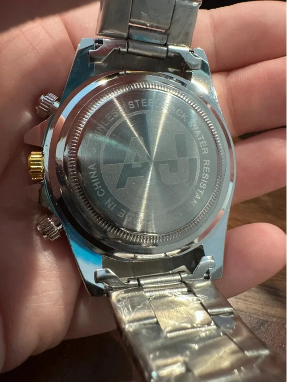 AJ watch, stainless steel, gold & silver toned, crimson red face
